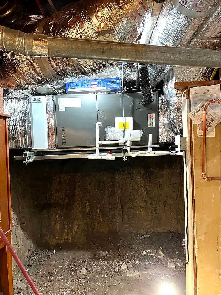 Air handler with insulated ducting installed in a basement crawlspace