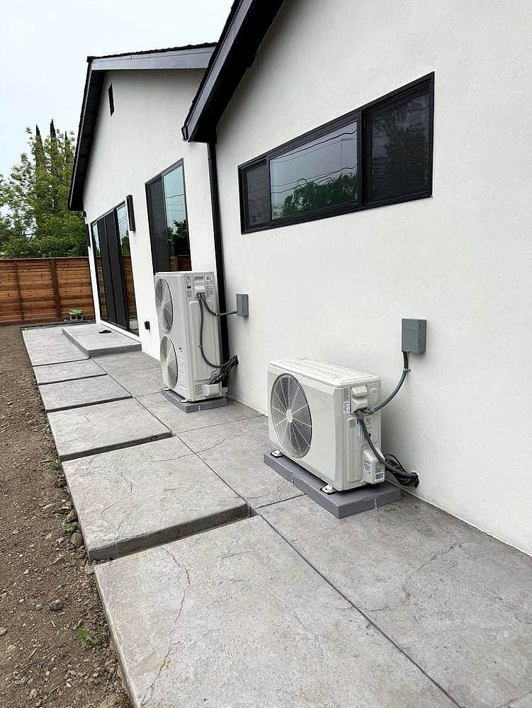 Two heat-pump condensers installed at a modern home