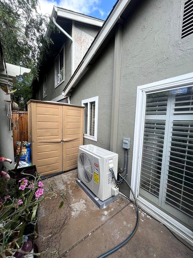 Bryant condenser installed on a garden patio