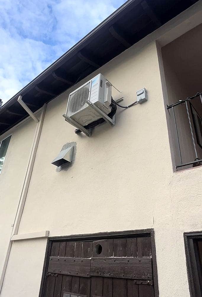 Daikin mini-split condenser wall-mounted on an upper story