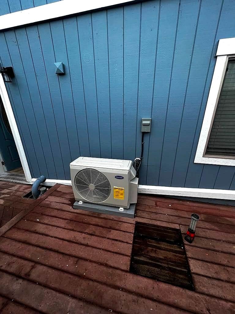 Carrier mini-split condenser installed on a backyard deck