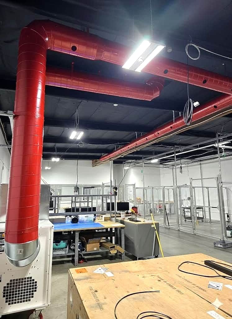 Red spiral ductwork installed in a warehouse