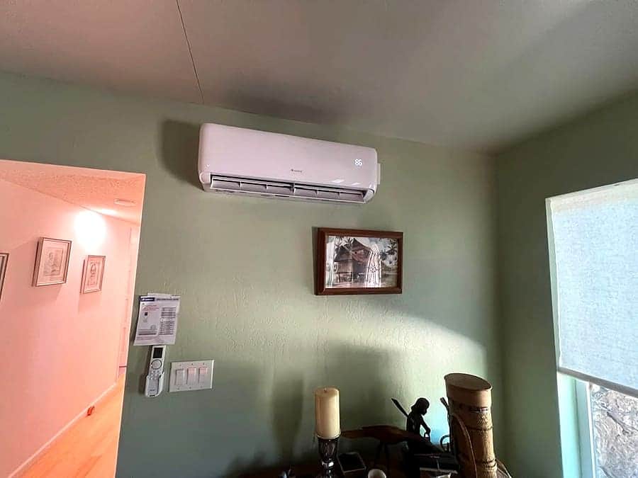 Wall-mounted mini-split head installed in a living room